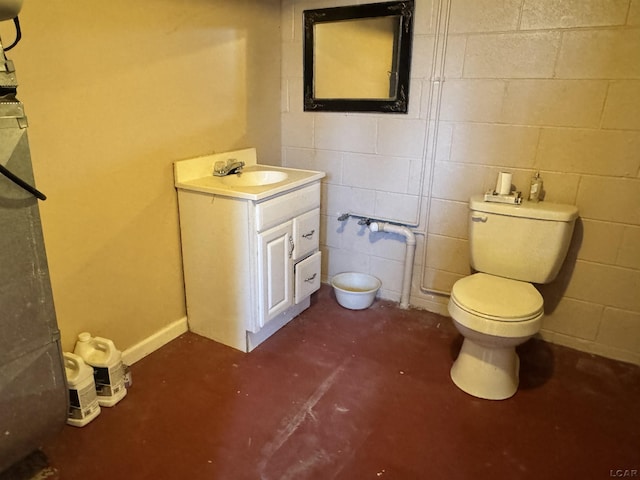 bathroom featuring concrete flooring, vanity, and toilet