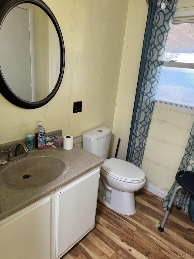 bathroom featuring hardwood / wood-style floors, vanity, and toilet