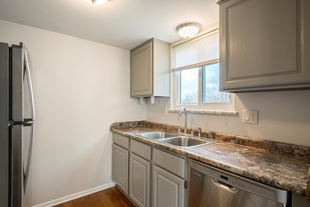 kitchen featuring gray cabinetry, sink, dark wood-type flooring, and stainless steel appliances