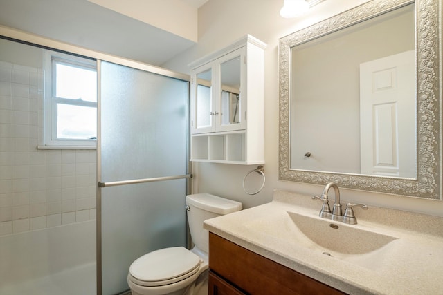 bathroom with vanity, toilet, and walk in shower