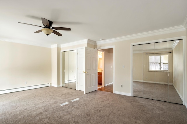 unfurnished bedroom featuring crown molding, carpet floors, two closets, and ceiling fan