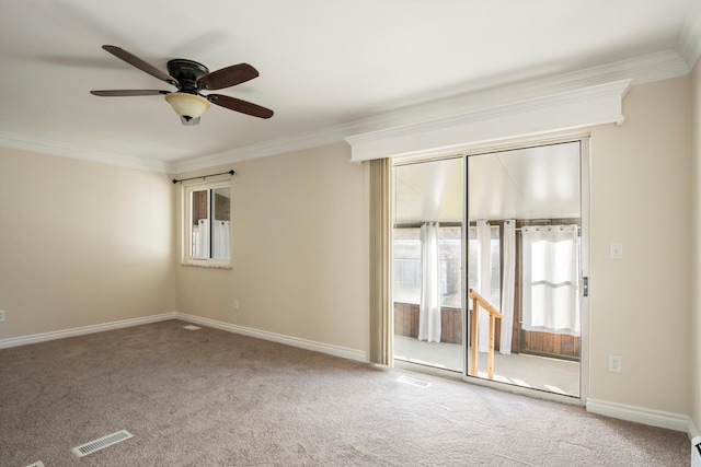 carpeted spare room with ceiling fan and ornamental molding