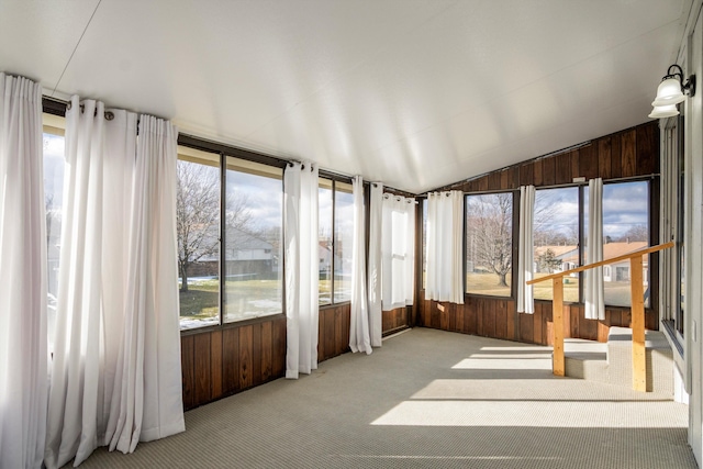 sunroom featuring lofted ceiling