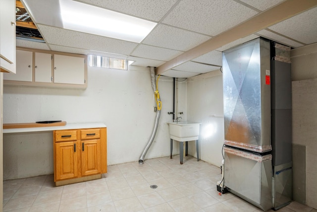 interior space with a paneled ceiling and heating unit