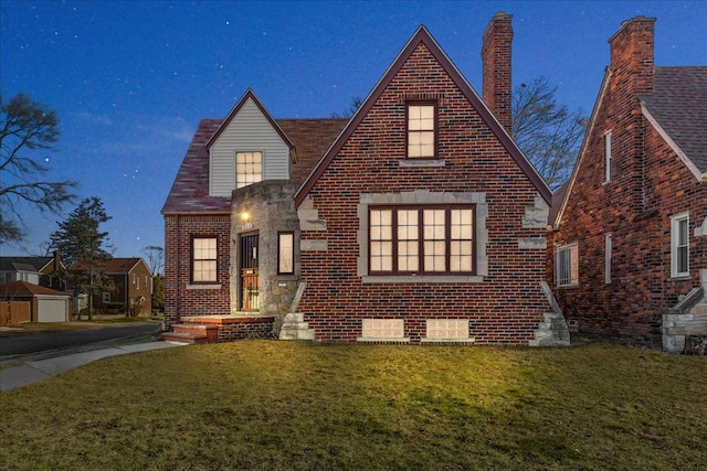 english style home with a front yard