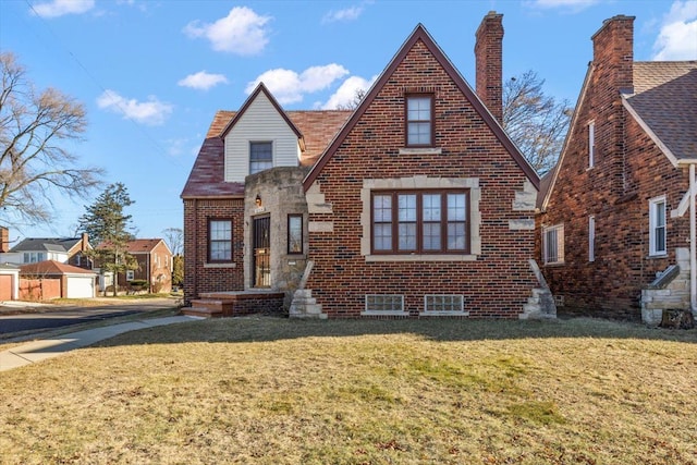 english style home with a front lawn