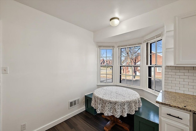 dining area with dark hardwood / wood-style floors