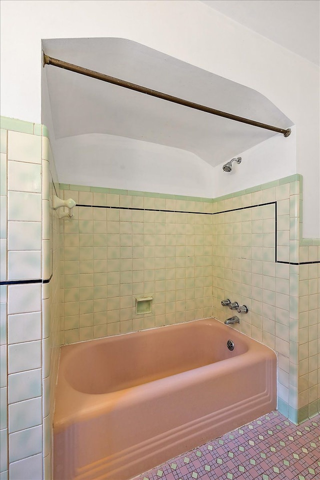 bathroom with tile patterned flooring and tiled shower / bath