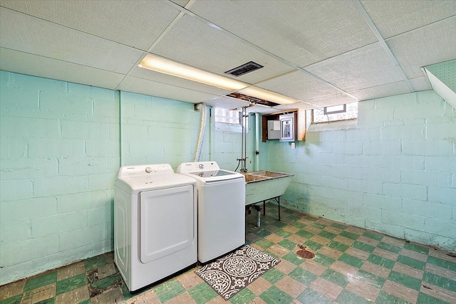 laundry area featuring washing machine and dryer and sink