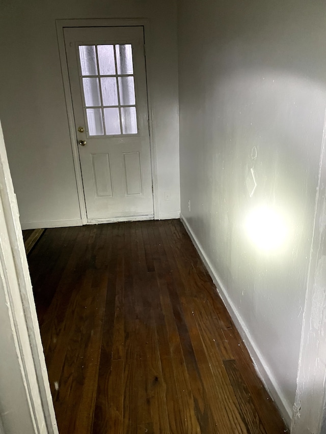 doorway with dark hardwood / wood-style floors