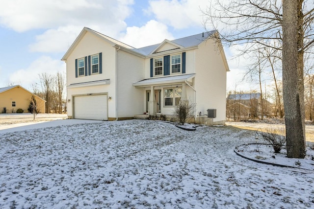 front of property featuring central AC unit and a garage