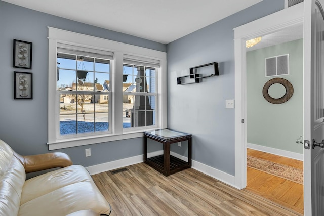 living area with hardwood / wood-style floors