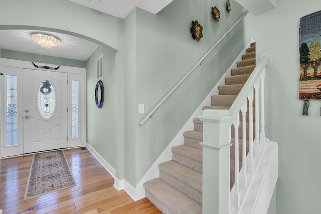 foyer entrance with light hardwood / wood-style floors and a healthy amount of sunlight