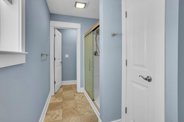 bathroom featuring a shower with shower door