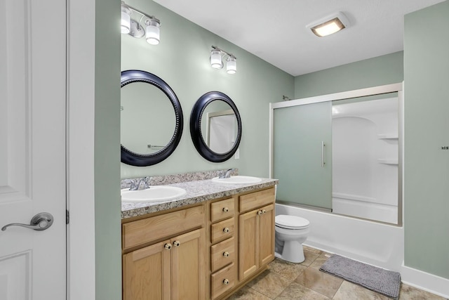 full bathroom featuring vanity, toilet, and shower / bath combination with glass door