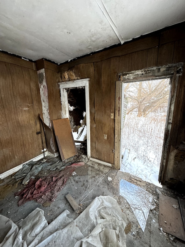 misc room featuring wooden walls