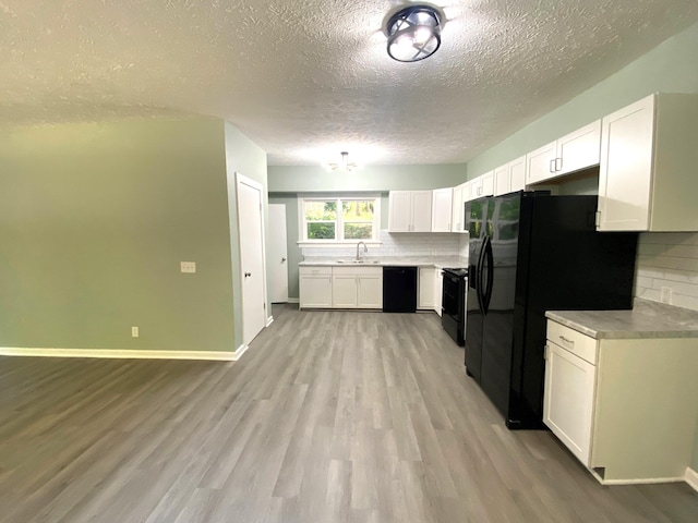 kitchen featuring sink, white cabinetry, and backsplash