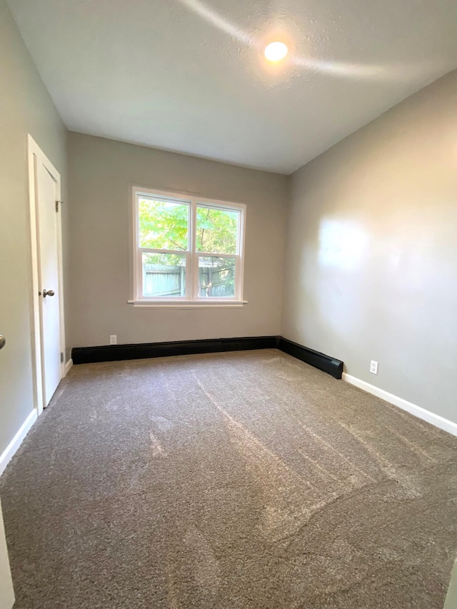 empty room with carpet flooring and a textured ceiling