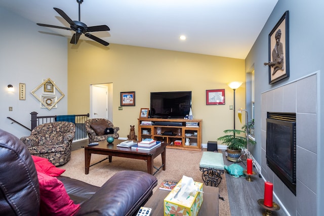 carpeted living room with ceiling fan and vaulted ceiling