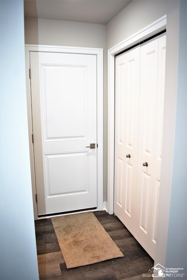 doorway with dark wood-type flooring