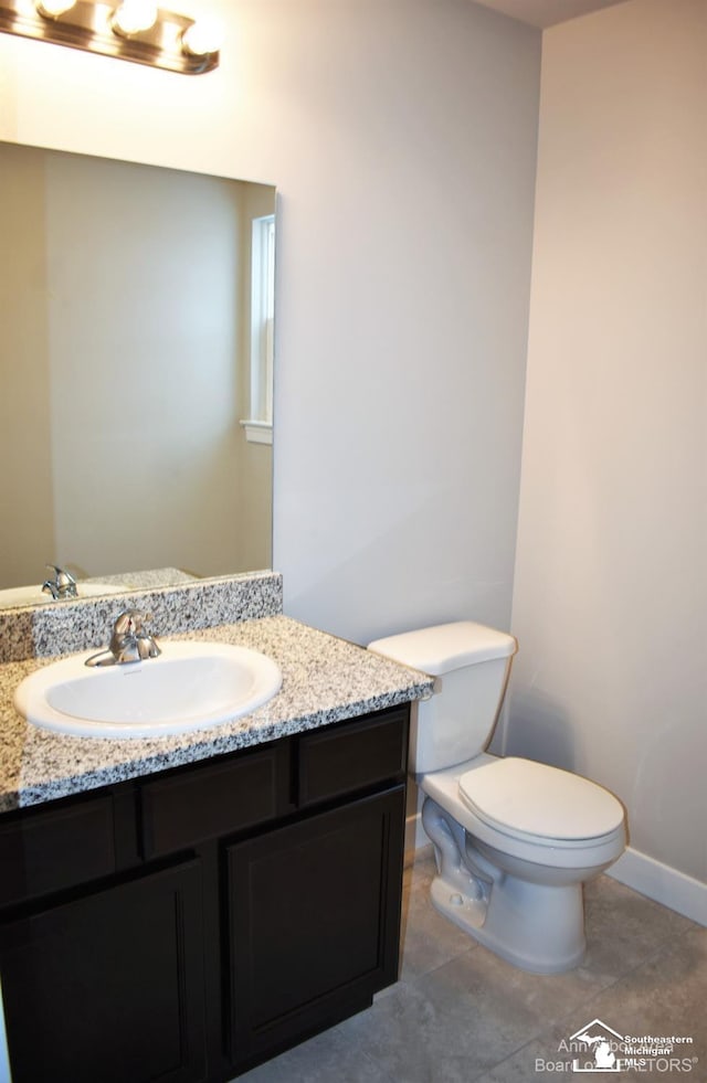 bathroom with vanity, toilet, and tile patterned flooring