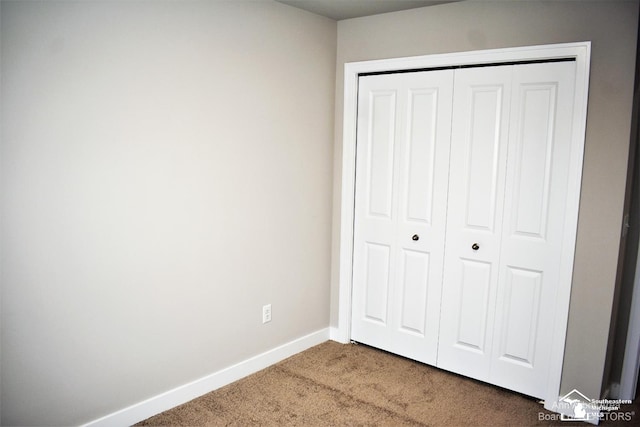 unfurnished bedroom featuring carpet floors and a closet