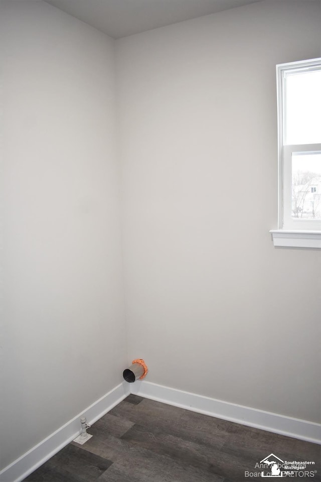 laundry room with dark wood-type flooring