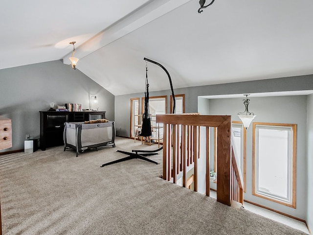 interior space with lofted ceiling with beams and light carpet