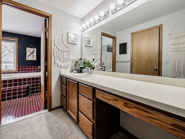 bathroom featuring a relaxing tiled tub and vanity