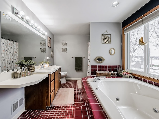 bathroom featuring toilet, tiled tub, and vanity