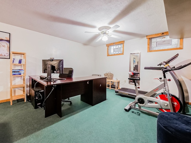 carpeted home office with a textured ceiling and ceiling fan