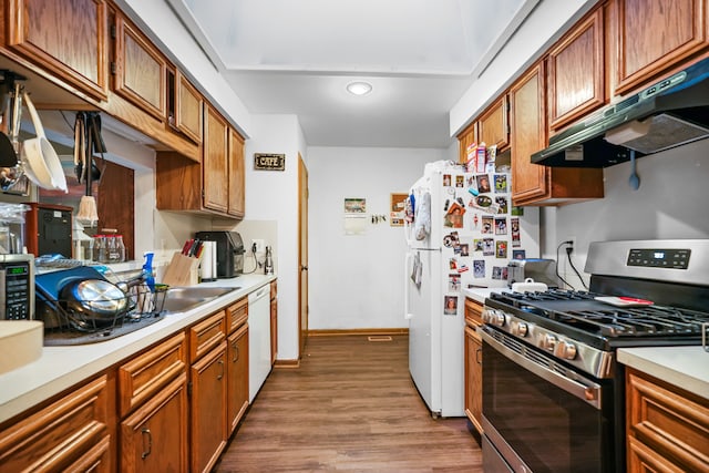 kitchen with white appliances and hardwood / wood-style flooring