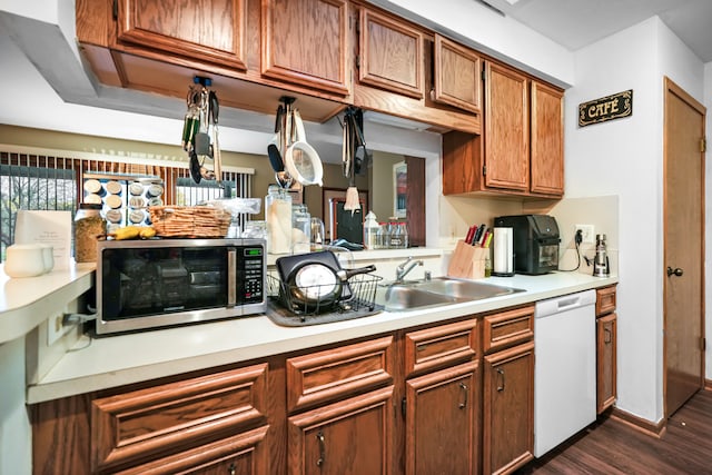 kitchen with dishwasher, dark hardwood / wood-style floors, and sink