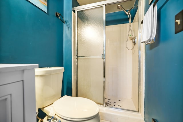 bathroom with vanity, toilet, and an enclosed shower