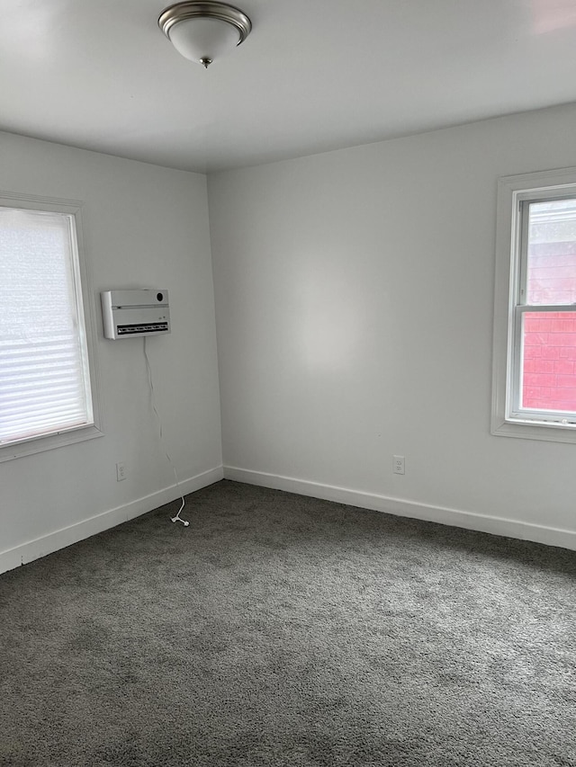 carpeted empty room with a wall mounted AC