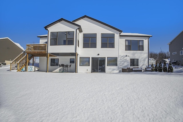 rear view of property featuring a deck