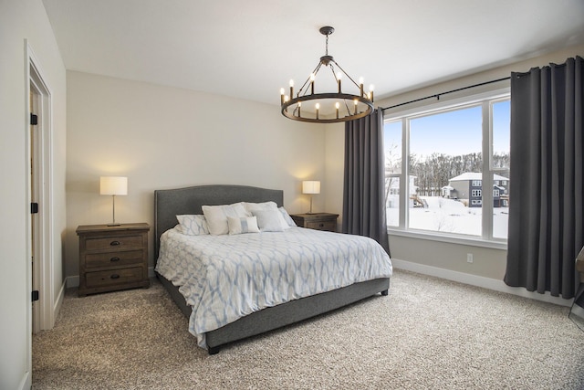 bedroom featuring carpet, multiple windows, and a notable chandelier