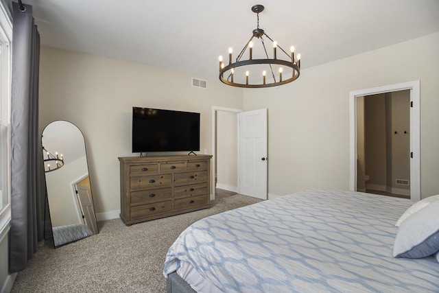 carpeted bedroom with an inviting chandelier