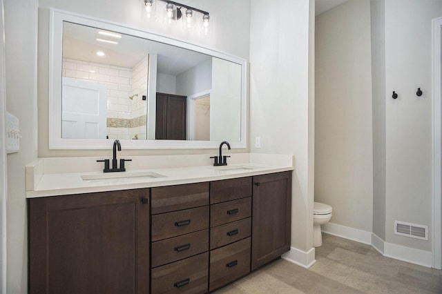 bathroom with vanity, toilet, and walk in shower