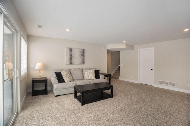 living room featuring light carpet