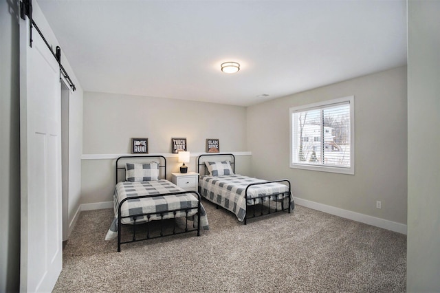 carpeted bedroom with a barn door