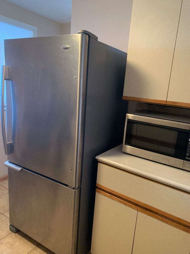 kitchen featuring stainless steel appliances and light tile patterned floors