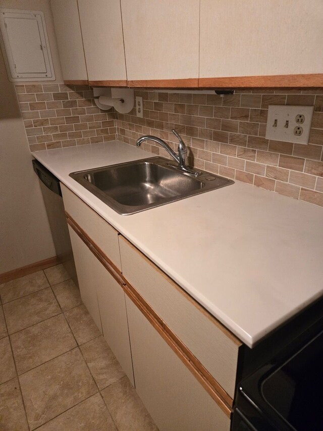 kitchen with tasteful backsplash, sink, and light tile patterned floors