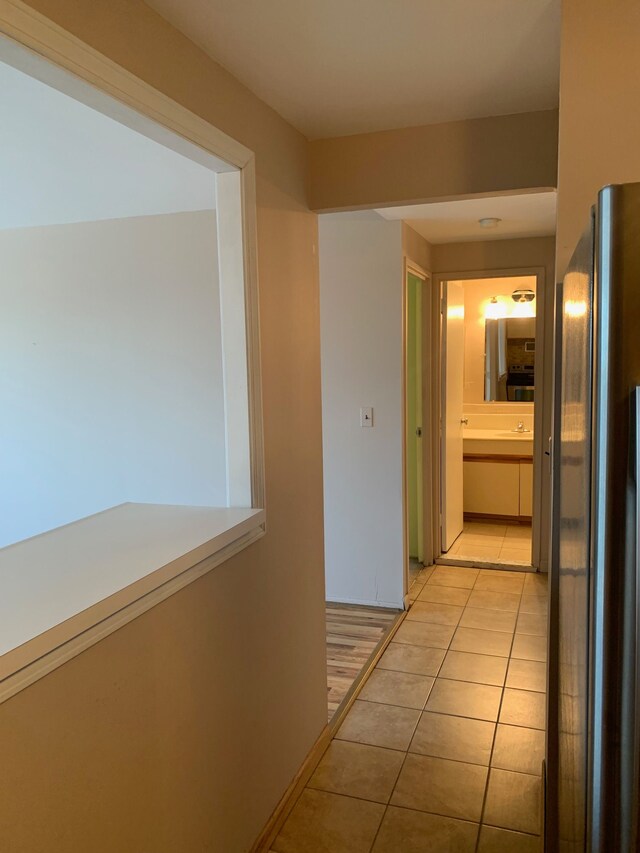 hall featuring light tile patterned floors