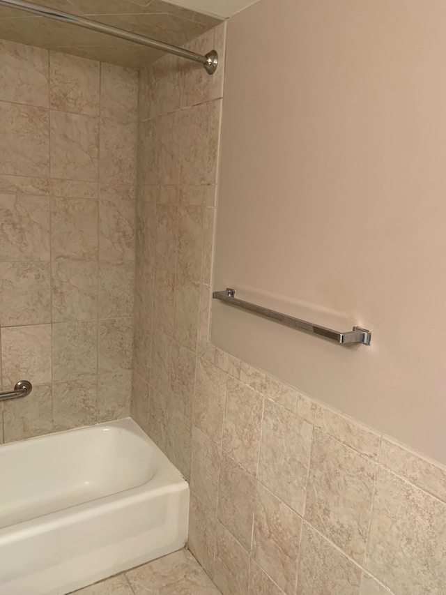 bathroom with tile patterned floors and tiled shower / bath combo