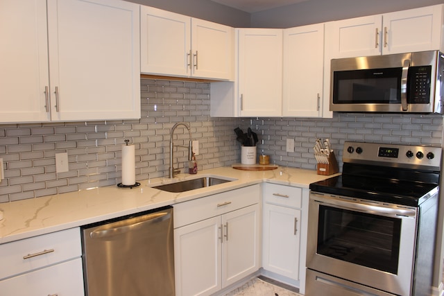 kitchen featuring white cabinetry, sink, appliances with stainless steel finishes, and tasteful backsplash