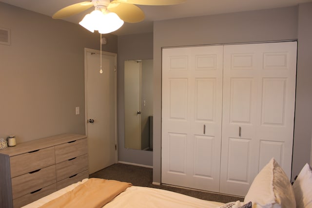 unfurnished bedroom featuring dark colored carpet and ceiling fan