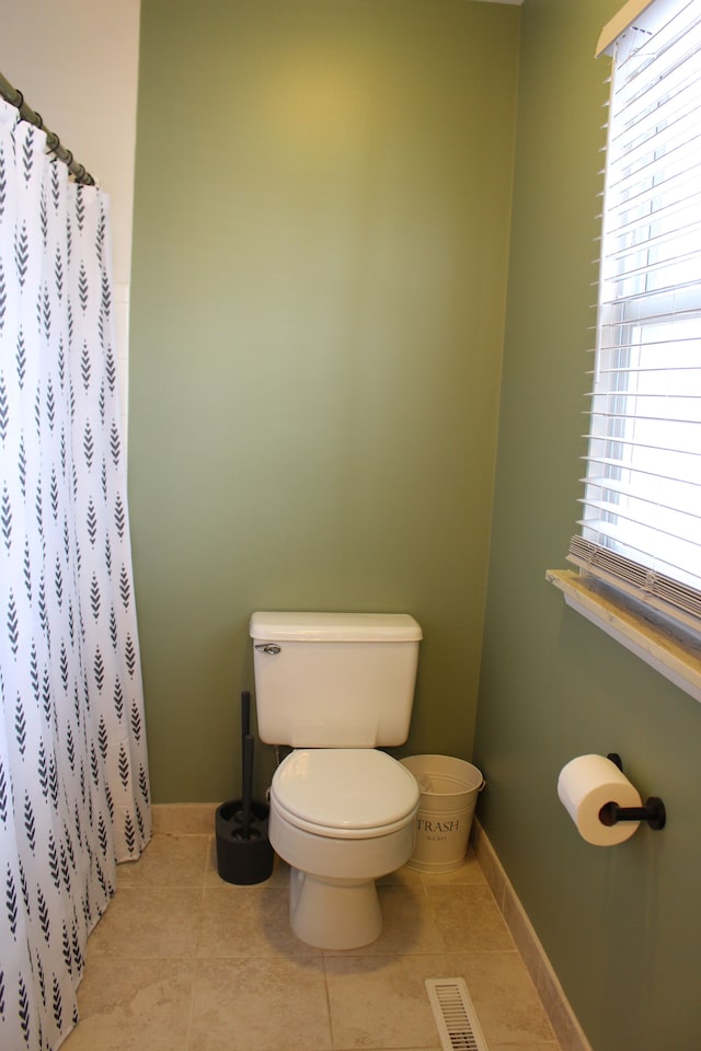 bathroom featuring tile patterned floors, toilet, and a shower with shower curtain