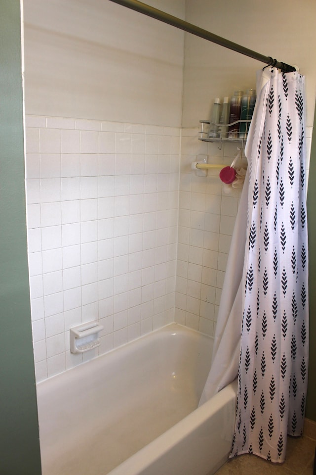 bathroom with tile patterned flooring and shower / bath combo with shower curtain