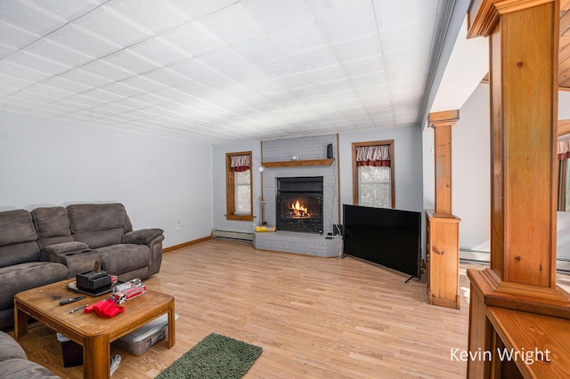 living room with light hardwood / wood-style floors, baseboard heating, and a fireplace